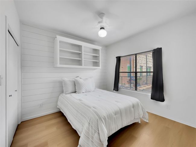 Bedroom with wood finished floors, baseboards, and a closet | Image 14