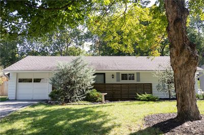 Ranch-style home with a garage and a front lawn | Image 2