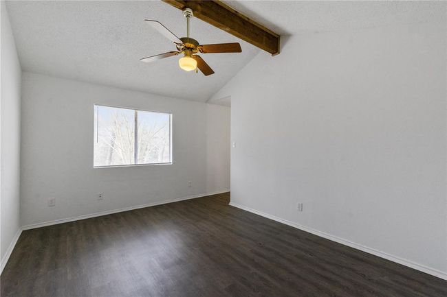 Primary Bedroom with natural wood beam, ceiling fan and ensuite master bathroom. | Image 11