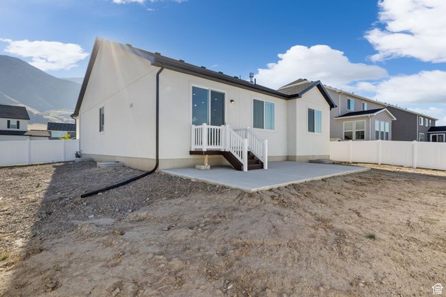 Rear view of house with a patio area, fence private yard, and a mountain view | Image 8