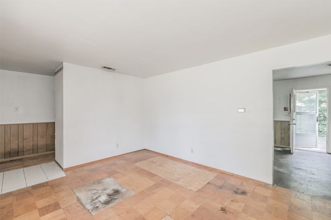 Unfurnished room with a wainscoted wall and wood walls | Image 10