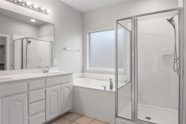 Full bath with a stall shower, double vanity, a bath, and tile patterned floors | Image 31