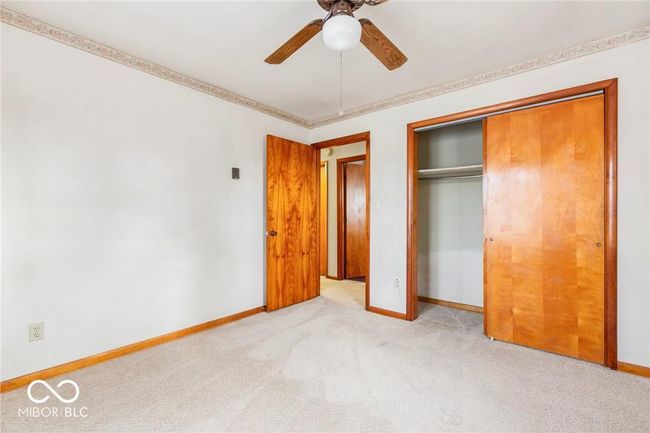 unfurnished bedroom featuring carpet, a closet, and a ceiling fan | Image 23