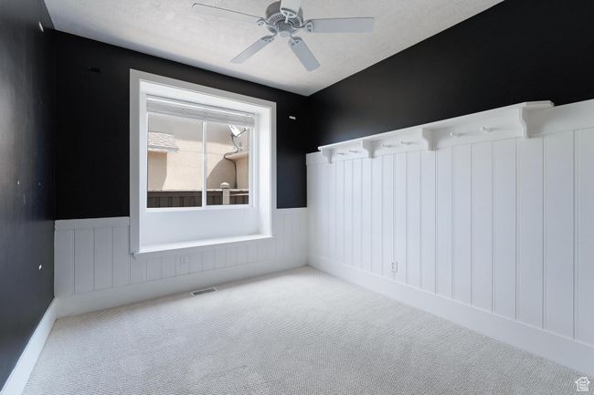 Bedroom 2 with wainscoting and a ceiling fan | Image 21