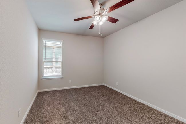 Spare room featuring carpet floors, a ceiling fan, and baseboards | Image 24