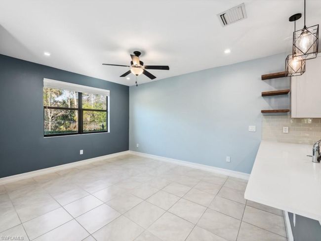 Spare room featuring light tile patterned floors and ceiling fan | Image 8