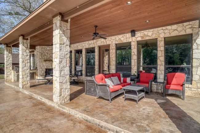 The outdoor space is amazing with a covered patio just steps from your swimming pool. Outdoor fireplace and built in BBQ grill with sink and granite counters. | Image 36