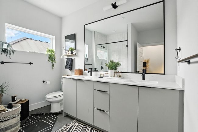Full bath with double vanity, tiled shower, and tile patterned flooring | Image 8