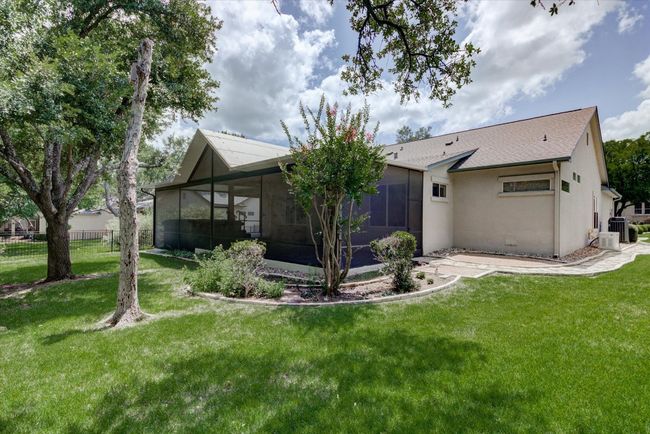 Rear view of property with a sunroom and stucco siding | Image 27