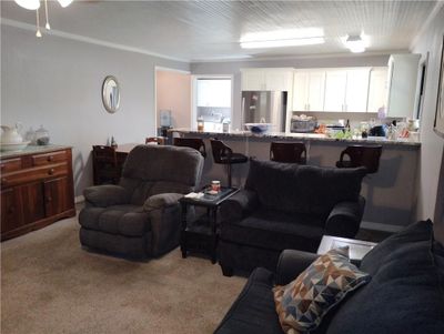 Living room featuring carpet flooring and crown molding | Image 2