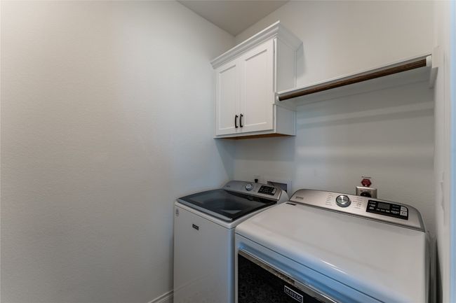 Washroom featuring washing machine and dryer and cabinet space | Image 18