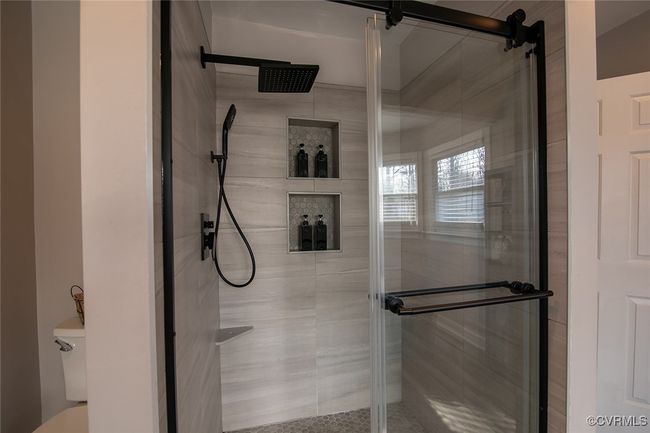 Full bathroom featuring toilet and a stall shower | Image 30