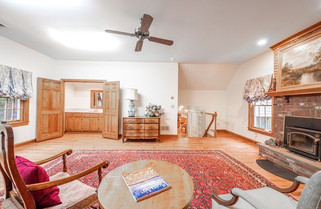 Family Room features wet bar behind doors and wood-burning stove. | Image 20