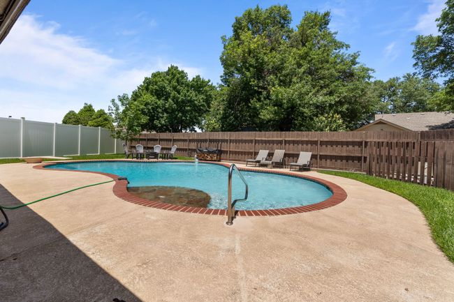 View of pool and a fenced backyard | Image 34