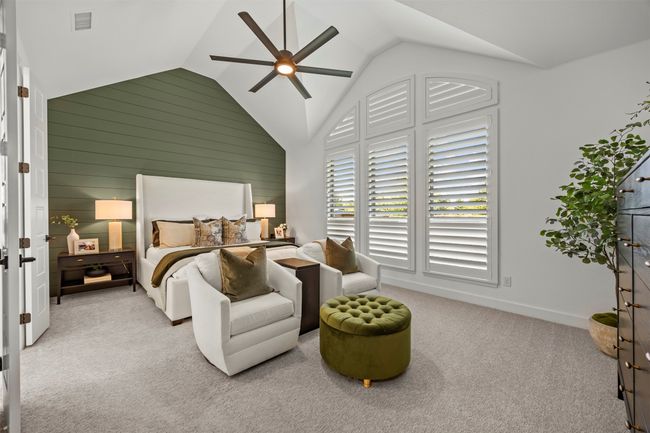 Bedroom with carpet flooring, a ceiling fan, and high vaulted ceiling | Image 20