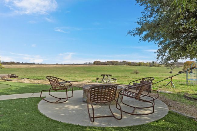View of patio featuring a fire pit and a view of rural / pastoral area | Image 19