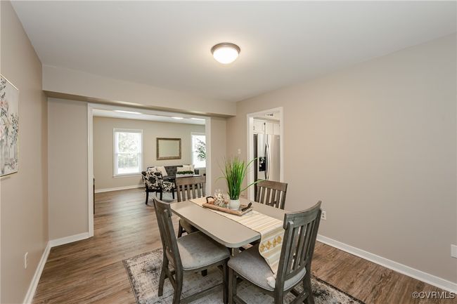 Dining area featuring baseboards and wood finished floors | Image 17