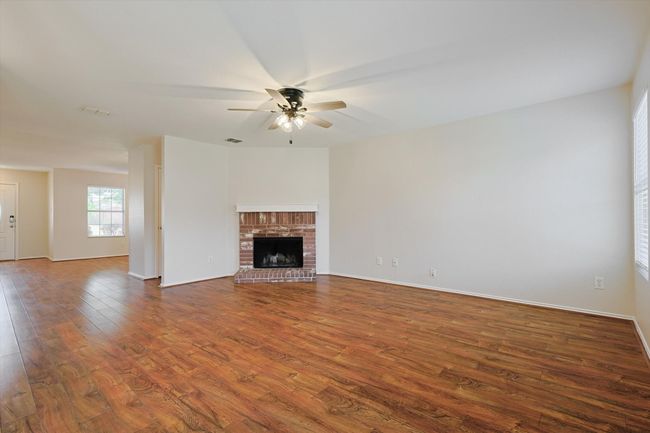 Living room with ceiling fan and Fireplace | Image 10