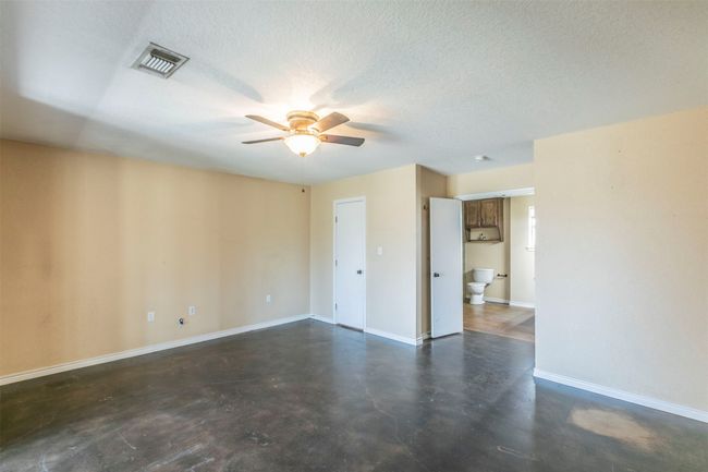 Unfurnished room featuring visible vents, ceiling fan, a textured ceiling, concrete flooring, and baseboards | Image 16