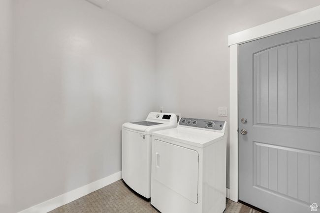 Laundry room with independent washer and dryer and light floors | Image 56