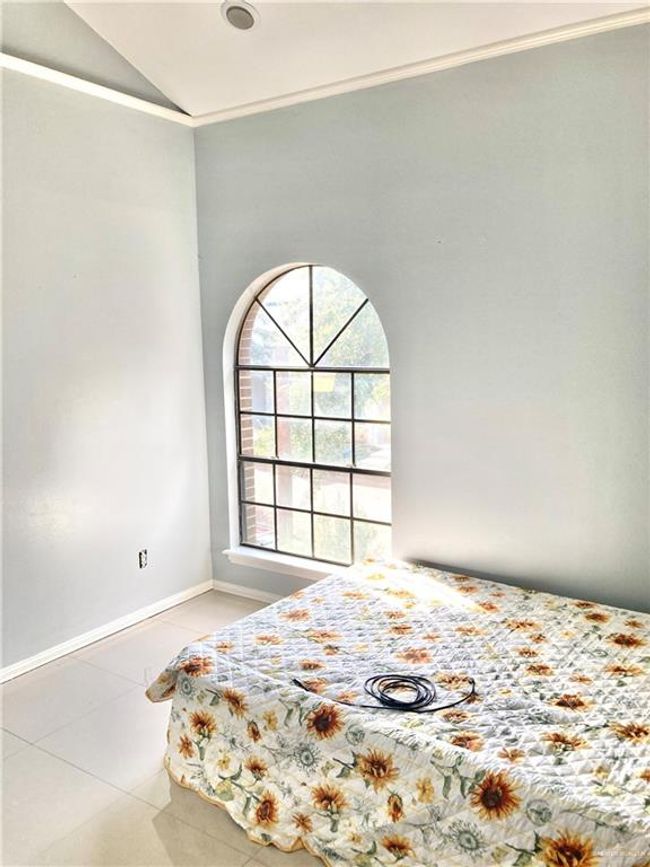 Bedroom featuring tile patterned flooring, vaulted ceiling, and ornamental molding | Image 16