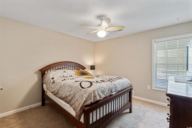 Bedroom with light carpet and a ceiling fan | Image 23