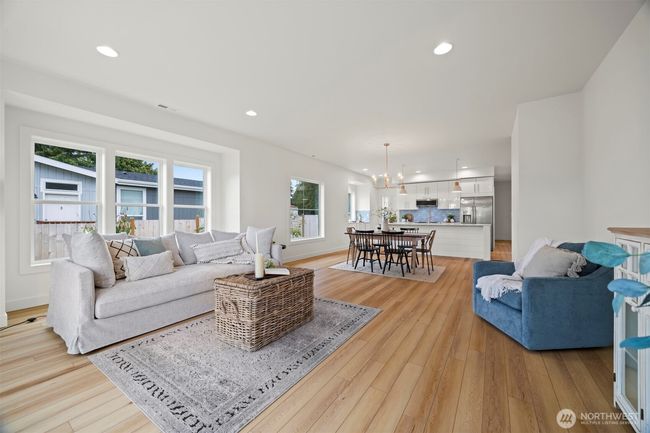 Looking across the living room toward the dining area with the kitchen beyond. This builder always has the best open floor plans! | Image 6