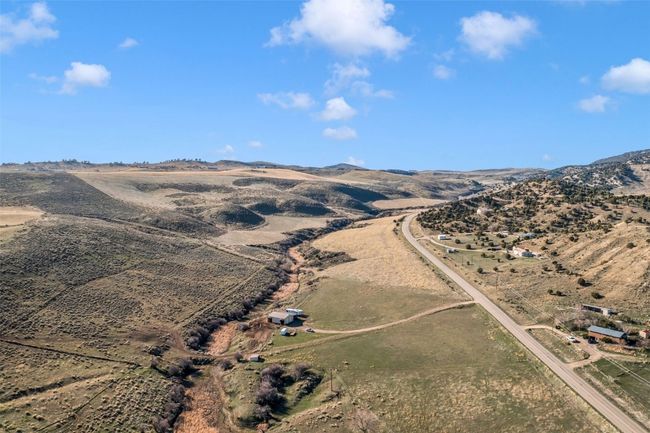 Aerial view of sparsely populated area with a mountainous background | Image 10