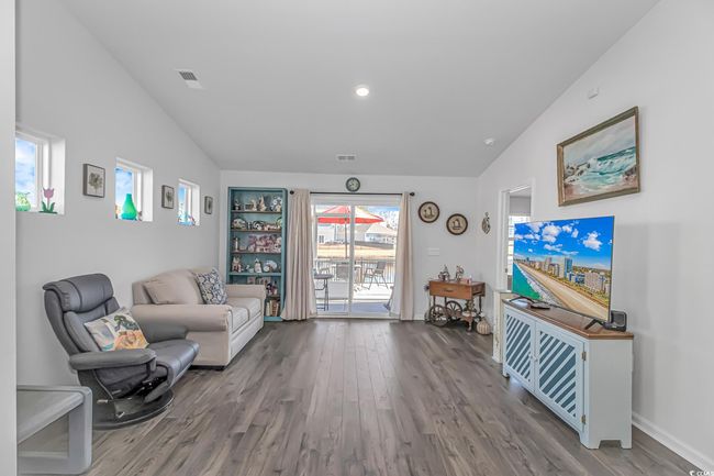 Sitting room featuring lofted ceiling and wood-type flooring | Image 8