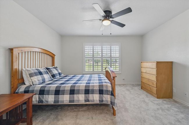 Bedroom featuring light carpet, baseboards, and a ceiling fan | Image 19