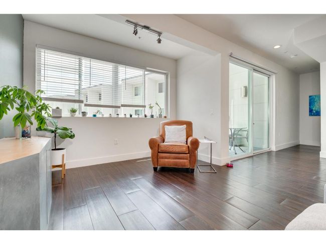 Sitting room featuring dark wood-style flooring, rail lighting, and recessed lighting | Image 11