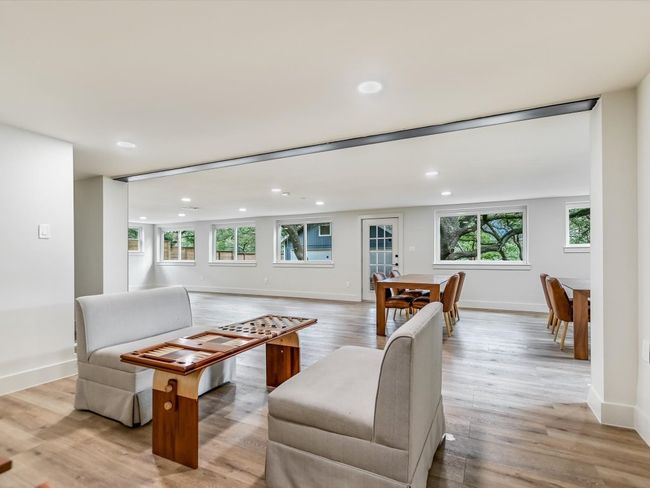 Living room featuring light wood-type flooring, a wealth of natural light, and recessed lighting | Image 7