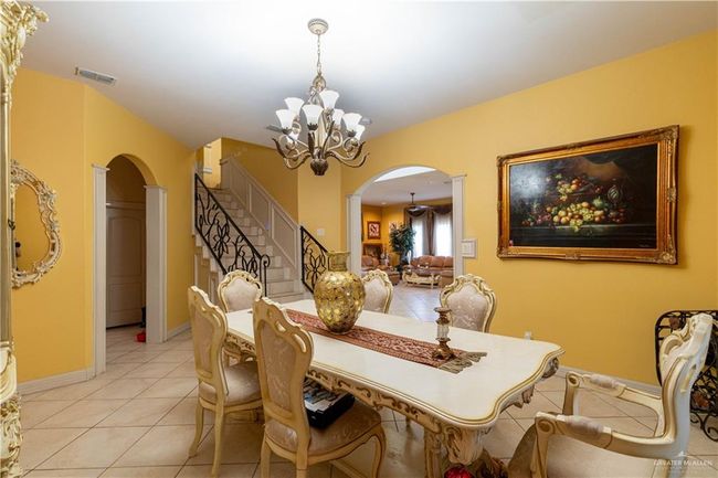 Tiled dining space featuring an inviting chandelier | Image 12