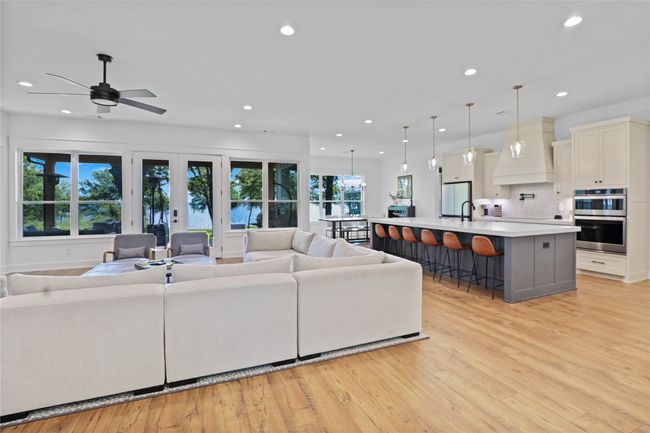 Living area featuring french doors, recessed lighting, light wood-style floors, and ceiling fan | Image 7