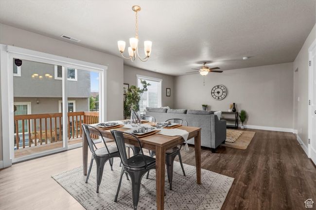 Dining room featuring ceiling fan, a chandelier, wood finished floors, and baseboards | Image 15
