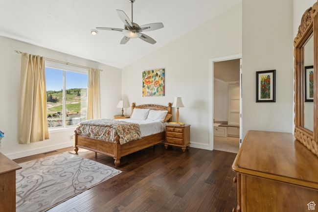 Bedroom featuring dark wood-style flooring, high vaulted ceiling, and a ceiling fan | Image 15