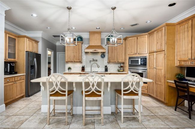 Fully upgraded kitchen with stainless steel appliances, custom cabinets, granite counters, large island with seating, and much more! | Image 7
