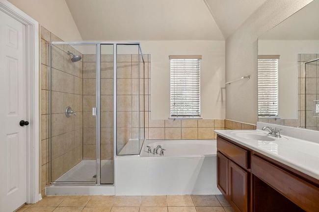Primary bathroom offers large soaking tub and separate shower | Image 20