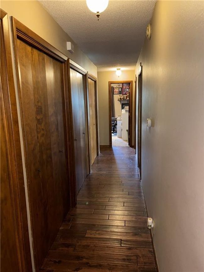 Corridor boasting 3 double door closets for maximum storage capacity | Image 9