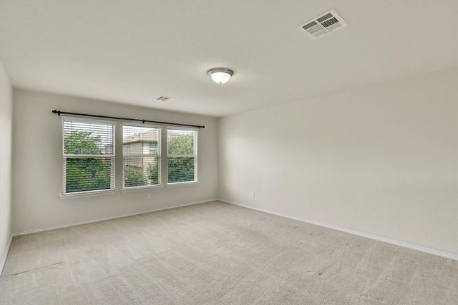 Spare room with light colored carpet, baseboards, and visible vents | Image 14