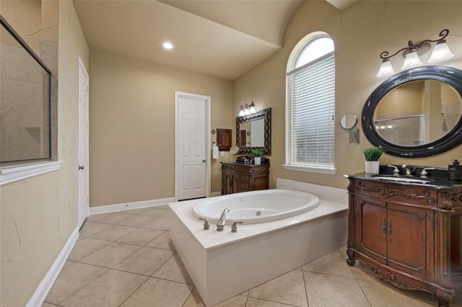 Bathroom featuring a bath, two vanities, and tile patterned floors | Image 22