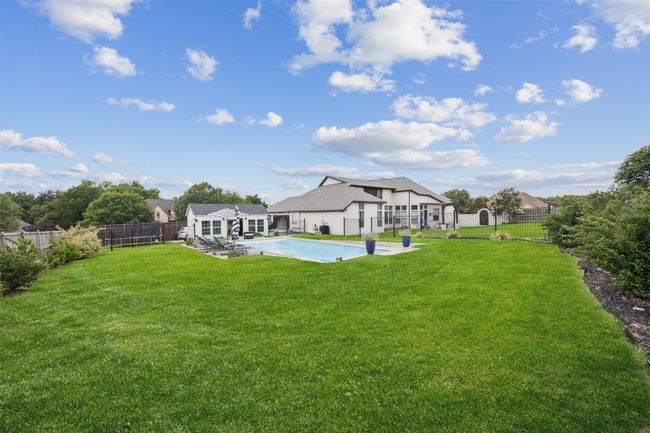 Fenced backyard with a storage shed and a patio | Image 32