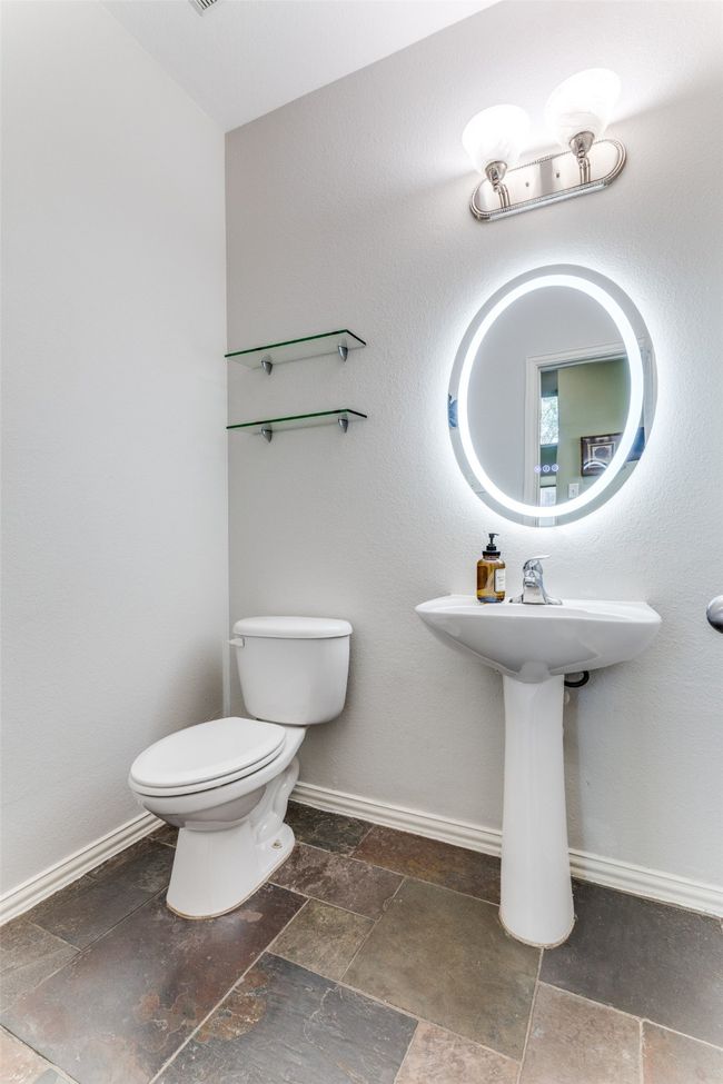 Bathroom with stone tile flooring and toilet | Image 16