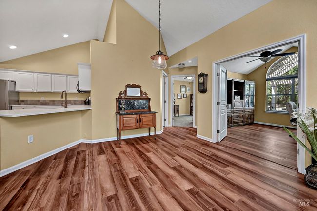 Living area with dark wood-style floors, ceiling fan, and high vaulted ceiling | Image 8