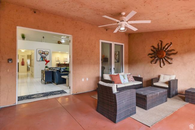 View of patio with an outdoor hangout area and a ceiling fan | Image 33