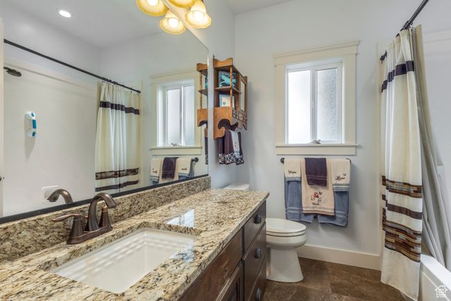 Bathroom featuring toilet, baseboards, a shower with curtain, vanity, and recessed lighting | Image 21