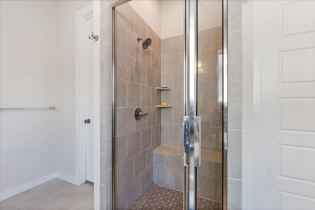 Full bathroom with tile patterned flooring, baseboards, and a stall shower | Image 22