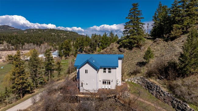 Birds eye view of property featuring a forest view and a mountain view | Image 75