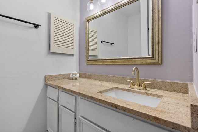 Bathroom featuring Quartz Countertop Vanity, Tiled Shower/Bathtub and Tile Floor | Image 24