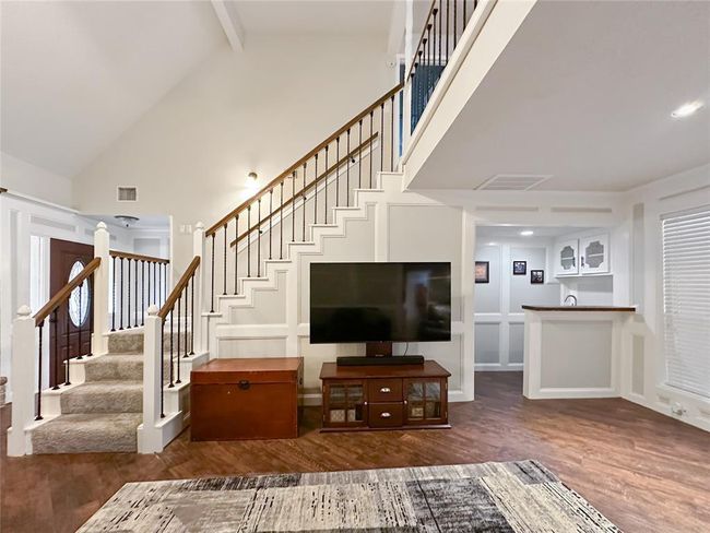Loft concept invites connection with a view of the recent paint, flooring and updated balusters. | Image 13